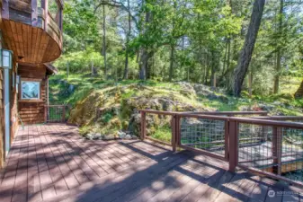 Sunny deck overlooks the fenced yard.