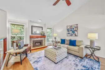 Formal living room includes vaulted ceiling, wall of windows, beautiful gas fireplace & mantle with decorative ceramic tile veneers, and ample space for entertaining.