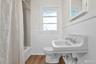 Nicely updated full bath with original medicine cabinet behind the mirror.