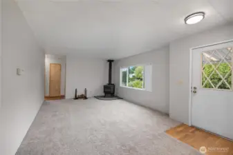 Entryway door to right leading into 2nd living space with wood burning fireplace!