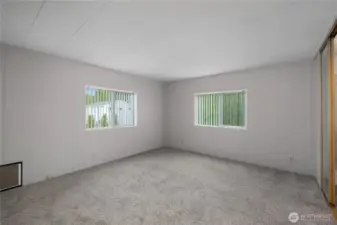 View of vacant primary bedroom - lots of natural light and view of backyard.