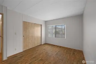 Vacant view of first bedroom on opposite wing of home.