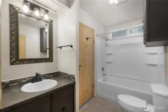 Hallway guest bath is also updated with new lighting, sinks, faucets, and paint. Directly located between additional bedrooms and main living spaces.