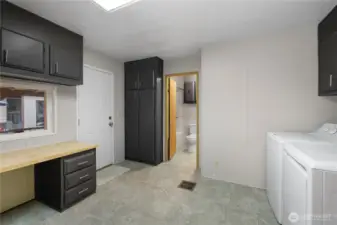 Alternate view of laundry space looking into guest bathroom - door to left leads to covered carport for easy access!