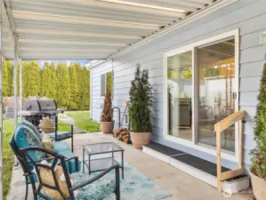 View of previous owners set up underneath awning - direct access to backyard with raised garden beds!