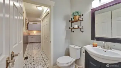 Main Floor bath with access to the laundry room which includes additional storage.