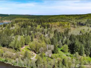 View of the driveway to the property with the open homesite with lake view.