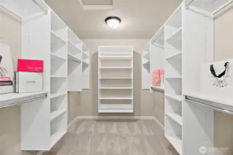 Tailored storage solutions provide organization and elegance in your spacious primary closet.