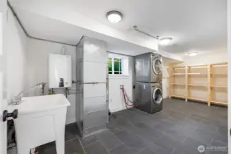 Laundry and storage with on demand hot water, gas furnace with heat pump outside for central heat and air. Added laundry sink and an added 120V plug for a kiln. A great space for art making or other hobbies.