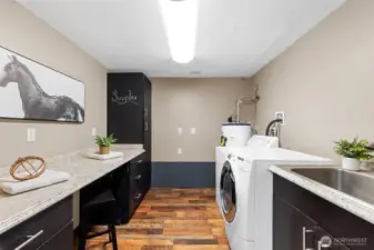 Spacious laundry room with utility sink, counter top for work space and added storage!