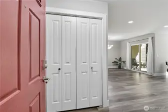 Entryway with spacious closet & open concept living.
