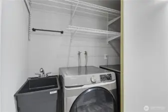 Laundry equipped with utility sink.