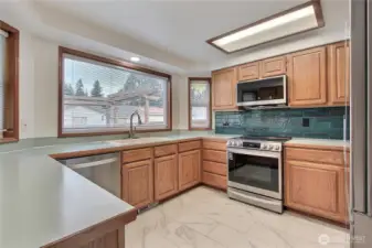 Kitchen view, LOVE the huge windows and all the counter space, newer matching stainless steel appliances.