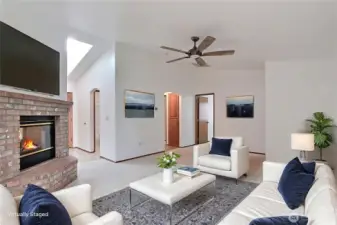 View from your living room towards entry, cathedral ceilings really open the home up and ceiling fan is a plus! ***Virtually Staged***