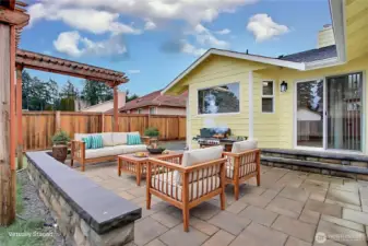 Backyard patio view, love the NEW professionally installed pavers, the pergola and the large patio doors leading from your kitchen/dining area. ***Virtually Staged***