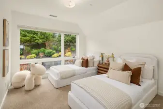 2nd level guest bedroom with views out to the private backyard and greenbelt.