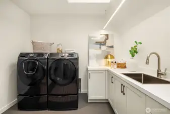 Upper level laundry.  Large space with built ins and utility sink.
