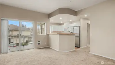 Living room with sliding glass doors that open up to a private balcony, bringing in fresh air and natural light.
