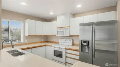 A bright and functional kitchen designed for both style and convenience, featuring cozy peninsula seating perfect for casual meals or entertaining guests.