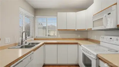 The kitchen is equipped with white cabinets and plenty of counterspace, combining style and functionality for all your culinary adventures.