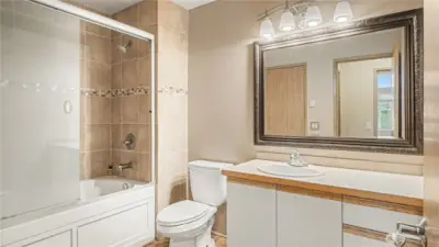 Main bathroom with ample counterspace and neutral color palate.
