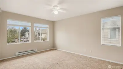 Another view of the primary bedroom, showcasing its open layout and abundance of natural light, perfect for relaxing and rejuvenating.