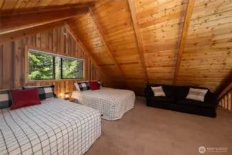 Loft with 2 queen beds and a couch.