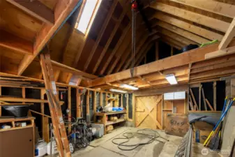 Detached shop is  equipped to store snowmobiles in the loft space during the off-season.