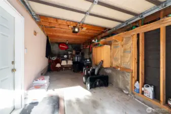 Attached 1-car garage with man-door to the rec room.
