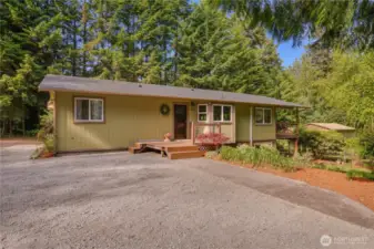 Welcome home to your peaceful forest retreat—charming curb appeal, new roof, and an inviting front deck nestled in nature.