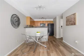Elegant hardwood flooring adds warmth and style to the kitchen and dining area