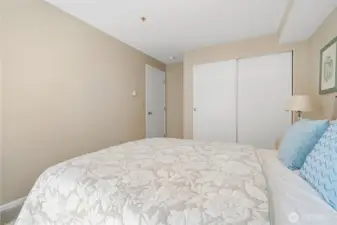 View from the bedroom’s rear showcasing ample closet space and easy access to the entry door