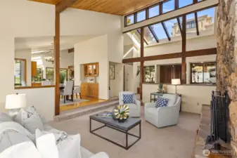 Looking back toward the front door, the dramatic skylights and clerestory windows fill the space with light, creating a bright and airy feel. The dining room features a convenient butler’s pantry with additional storage.
