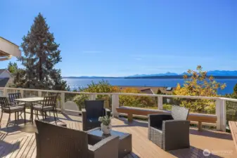 The largest of the three decks features built-in seating and sweeping views, with access from both the dining room and kitchen—perfect for effortless al fresco dining and entertaining.