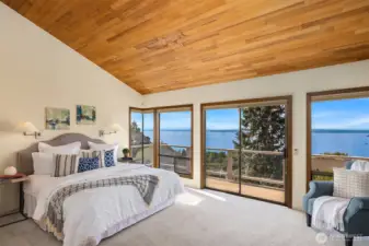 The upper level is dedicated to the primary suite, featuring vaulted ceilings and a private deck with the home’s best views—creating a peaceful retreat.