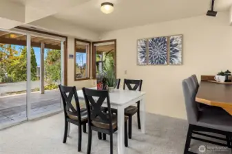 A closer look at the lower-level's game or eating area with a slider to the front patio. kitchenette with sink and mini-fridge