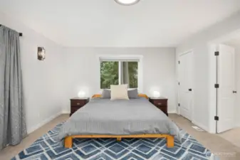 Large primary bedroom with private balcony, two closets & ensuite bathroom