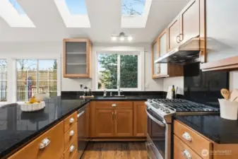 Light filled kitchen with tons of counter space and gas cooking