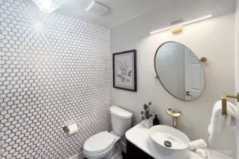 Designer inspired powder room with tile wall accent