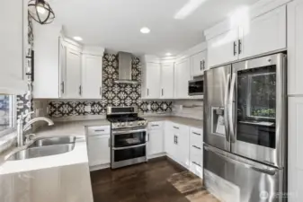 Stylishly remodeled kitchen and bathrooms feature designer fixtures, quartz counters, SS appliances, gas range, custom cabinets and tile.