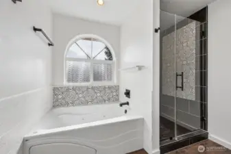 Remodeled primary bathroom with jetted soaking tub.