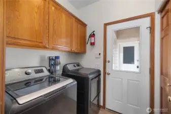 Laundry room is upstairs.  Doors lead to covered breezeway to the 3 car garage.