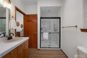 Walk-in shower and sinks in primary suite