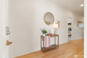 Open entryway with hardwood floors.