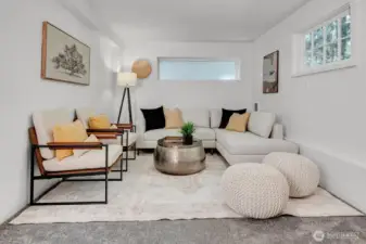 Roomy recreation room located in the daylight basement, ideal for entertaining, media, or flexible living space.