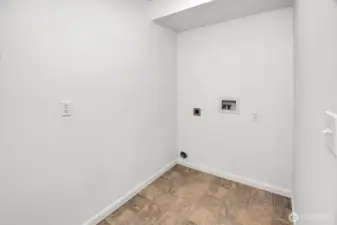 Large utility room with ample space for cabinetry and storage.