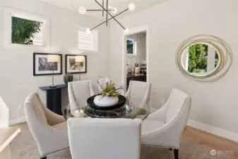 The Formal Dining room located at the North West Corner of the home.  In this picture you can see the Clear strory windows and the doorway to the butlers pantry which leads to the kitchen.