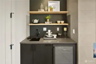 The Beverage Station is a true highlight, featuring a sleek sink with a glass washer and a convenient refrigerator, perfect for storing drinks, medications, or natural beauty products. This thoughtfully designed space adds both function and flair to your home.