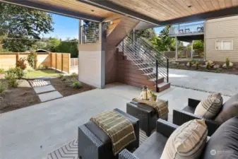 The view from the lower level deck space looking toward the yard, driveway and alley entrance.