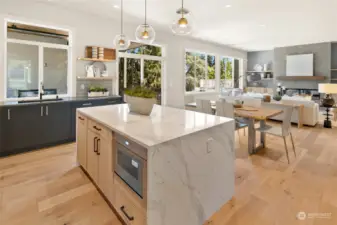 The view from the kitchen to the great room. Note the waterfall quartz end of the island.